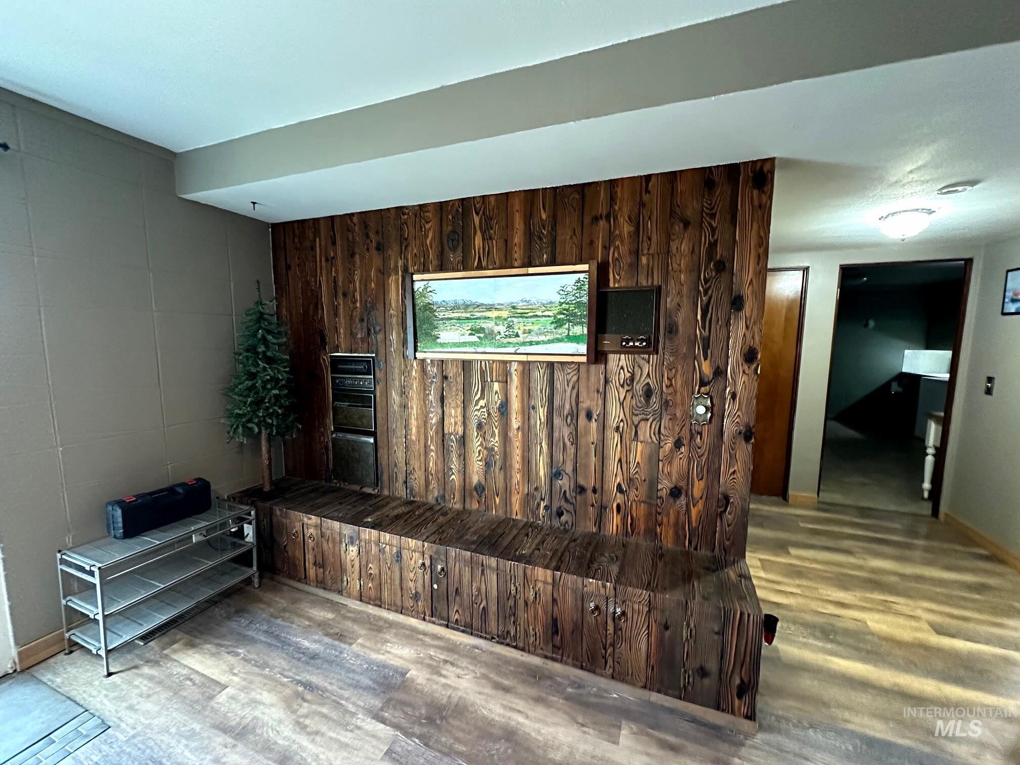 4436 Baker Road Ontario, OR 97914 - Photo 23 of 41 Living area featuring wooden walls, light wood finished floors, and an accent wall