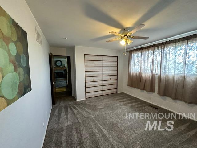 4436 Baker Road Ontario, OR 97914 - Photo 39 of 41 Unfurnished bedroom featuring a closet, dark colored carpet, and ceiling fan