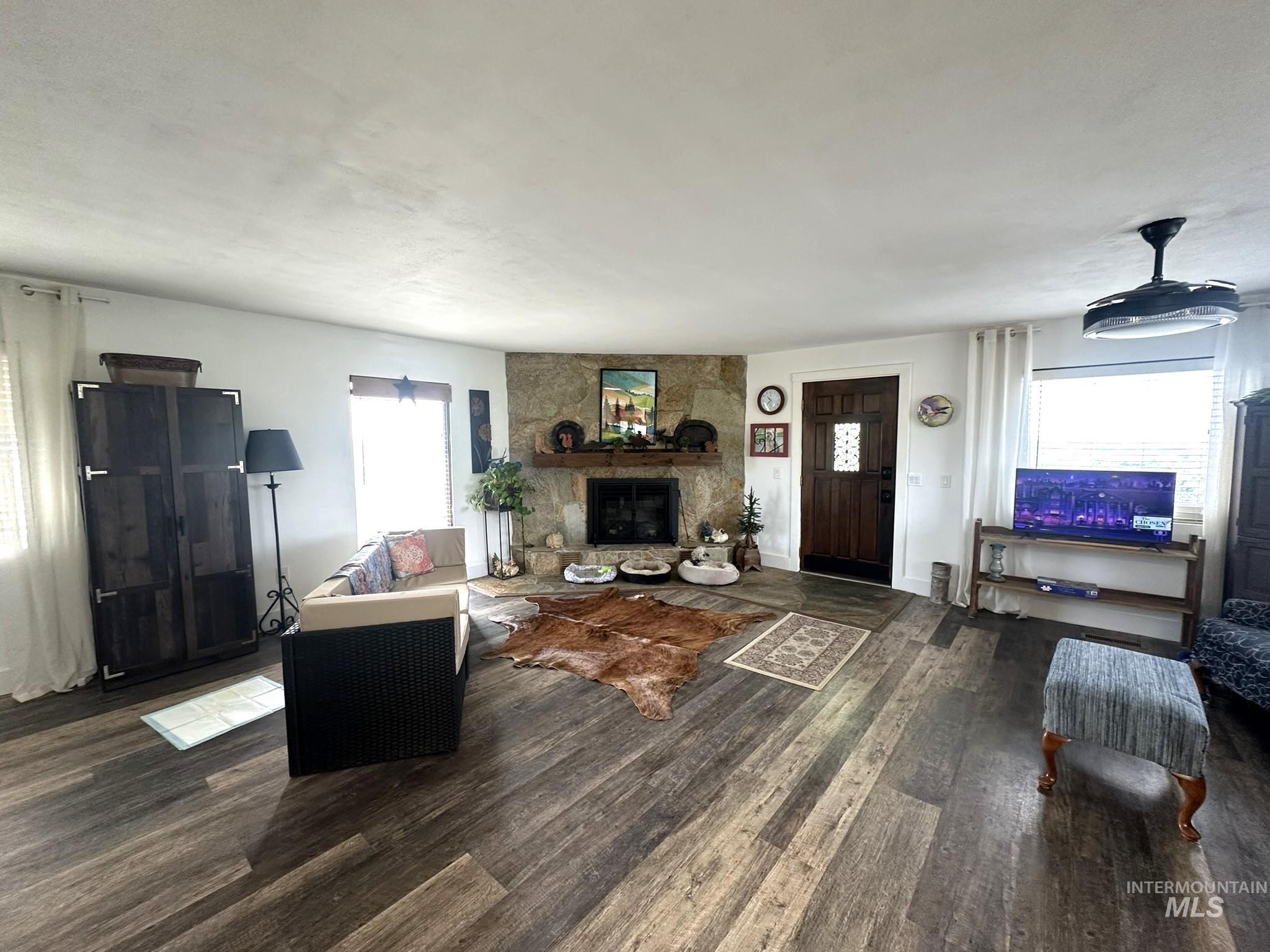 4436 Baker Road Ontario, OR 97914 - Photo 8 of 30 Living room with dark wood finished floors and a stone fireplace