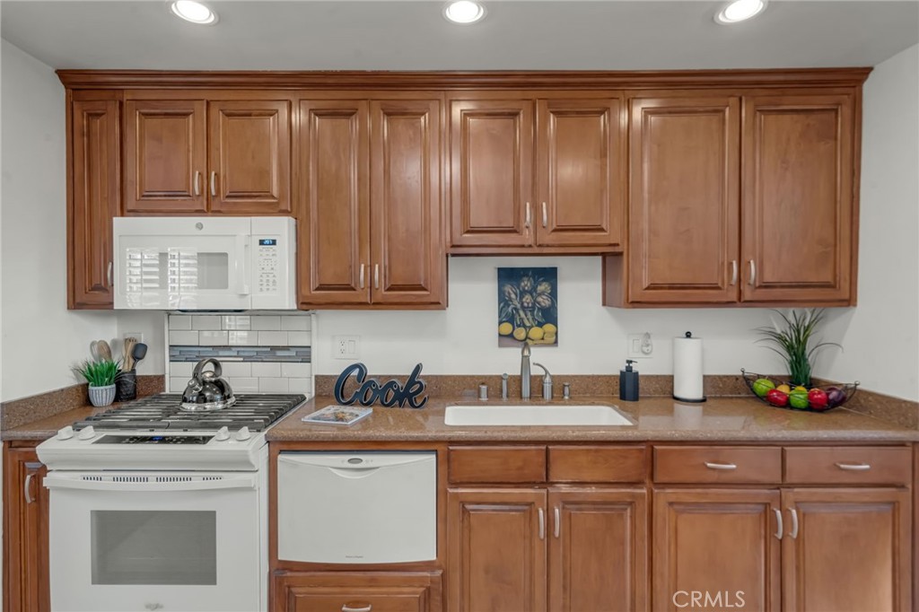 5142 West 142nd Street Hawthorne, CA 90250 - Photo 13 of 56 a kitchen with stainless steel appliances granite countertop a sink stove and cabinets