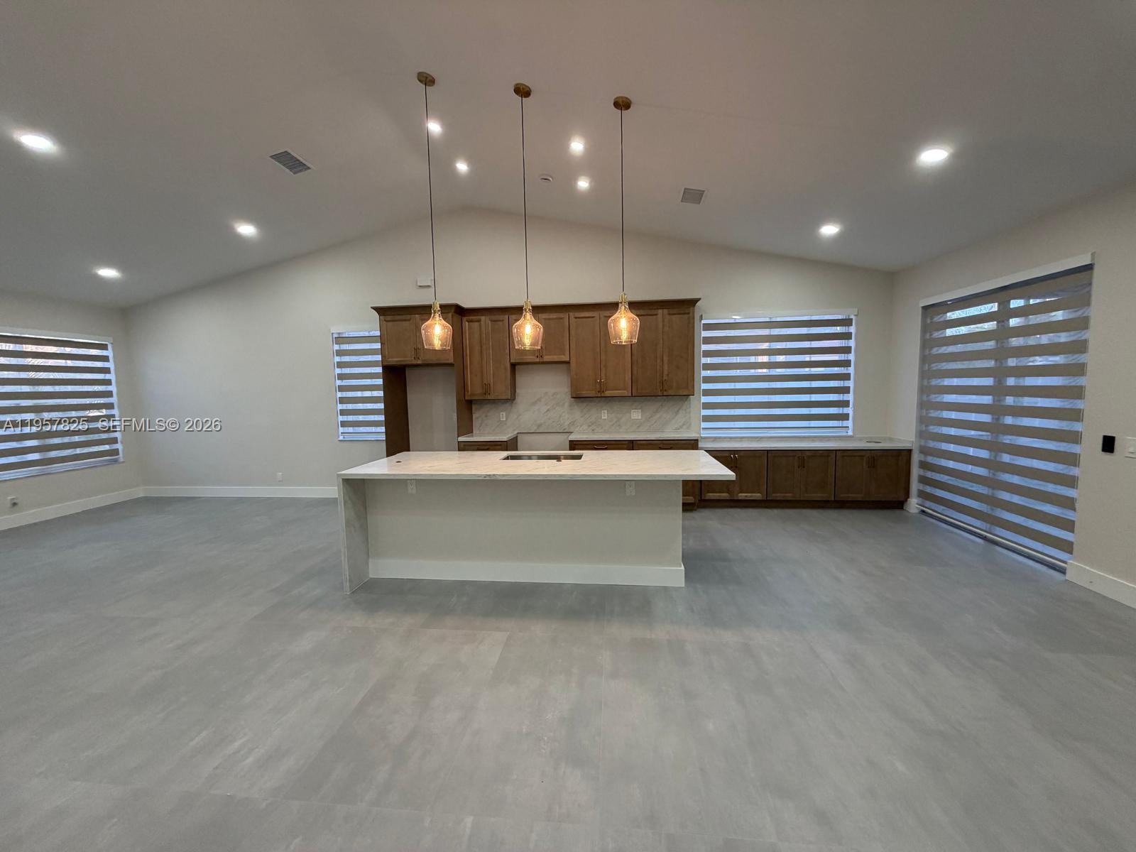a view of kitchen with windows and dual sinks