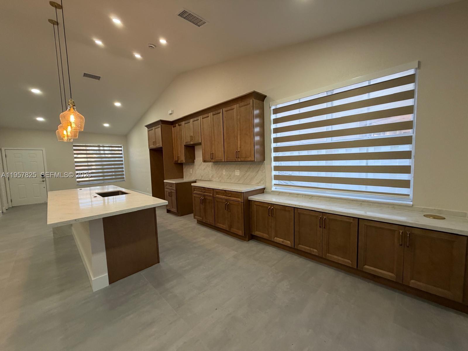755 Falling Water Road Weston, FL 33326 - Photo 13 of 52 a large kitchen with stainless steel appliances a large counter top