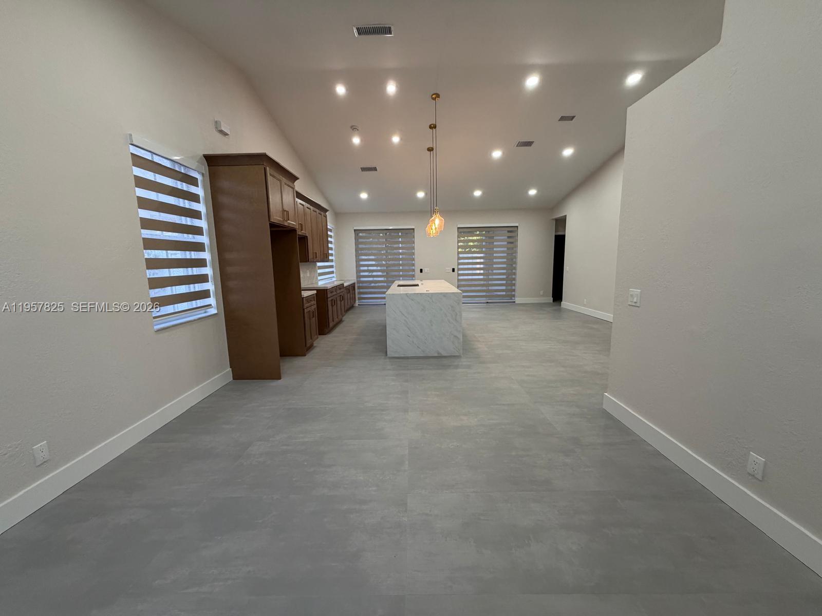 755 Falling Water Road Weston, FL 33326 - Photo 15 of 52 a view of a kitchen with furniture and a projector