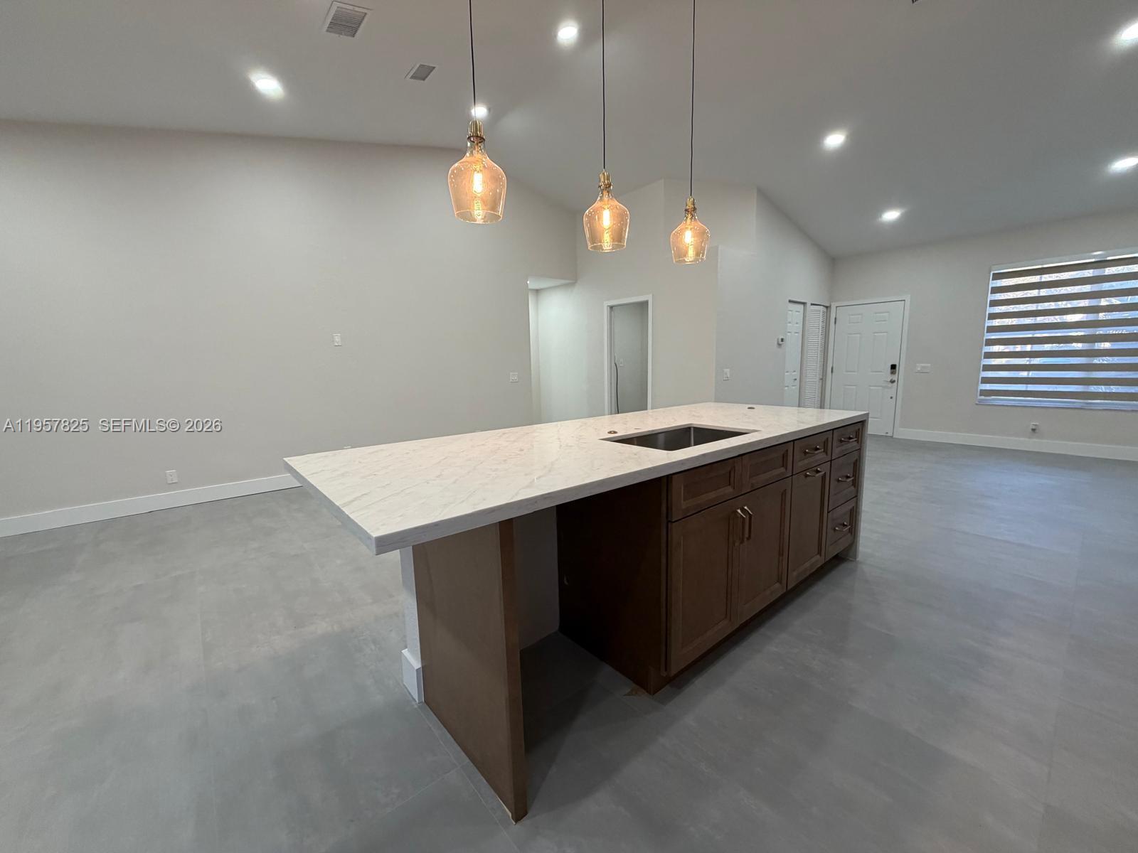 755 Falling Water Road Weston, FL 33326 - Photo 16 of 52 a kitchen with a sink a counter space and a window