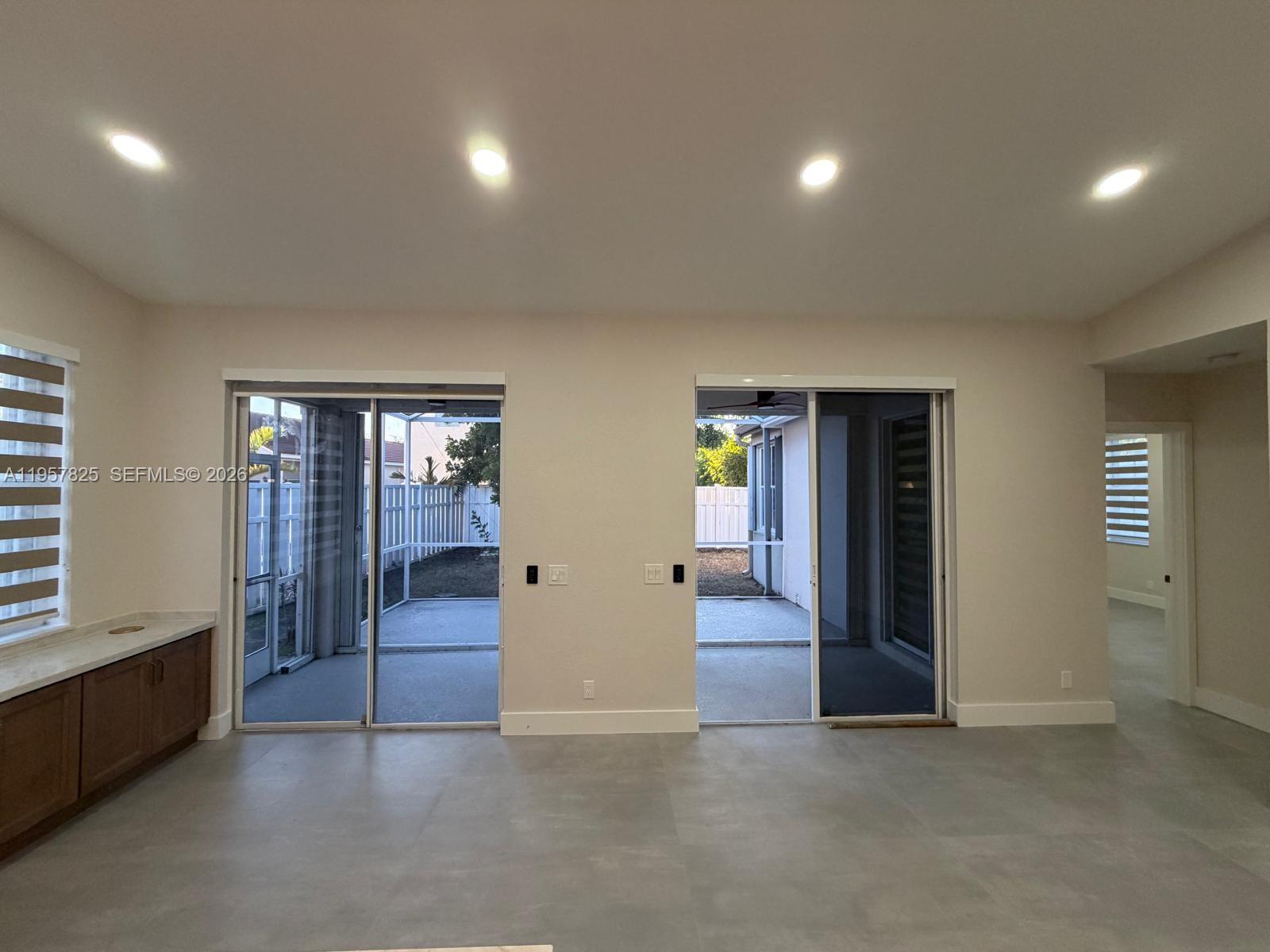 755 Falling Water Road Weston, FL 33326 - Photo 17 of 52 an empty room with windows and cabinet