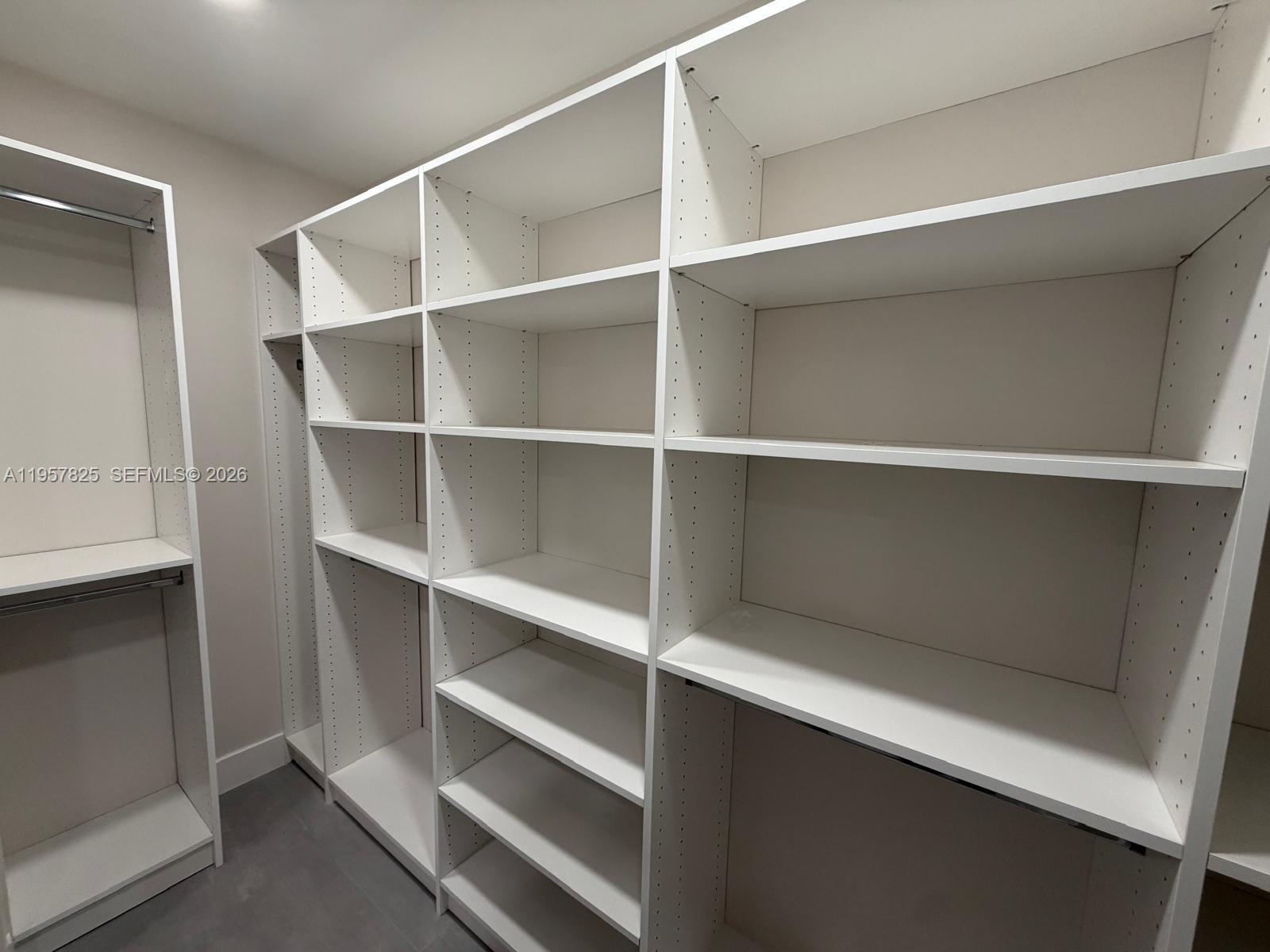 755 Falling Water Road Weston, FL 33326 - Photo 28 of 52 a view of walk in closet with empty racks