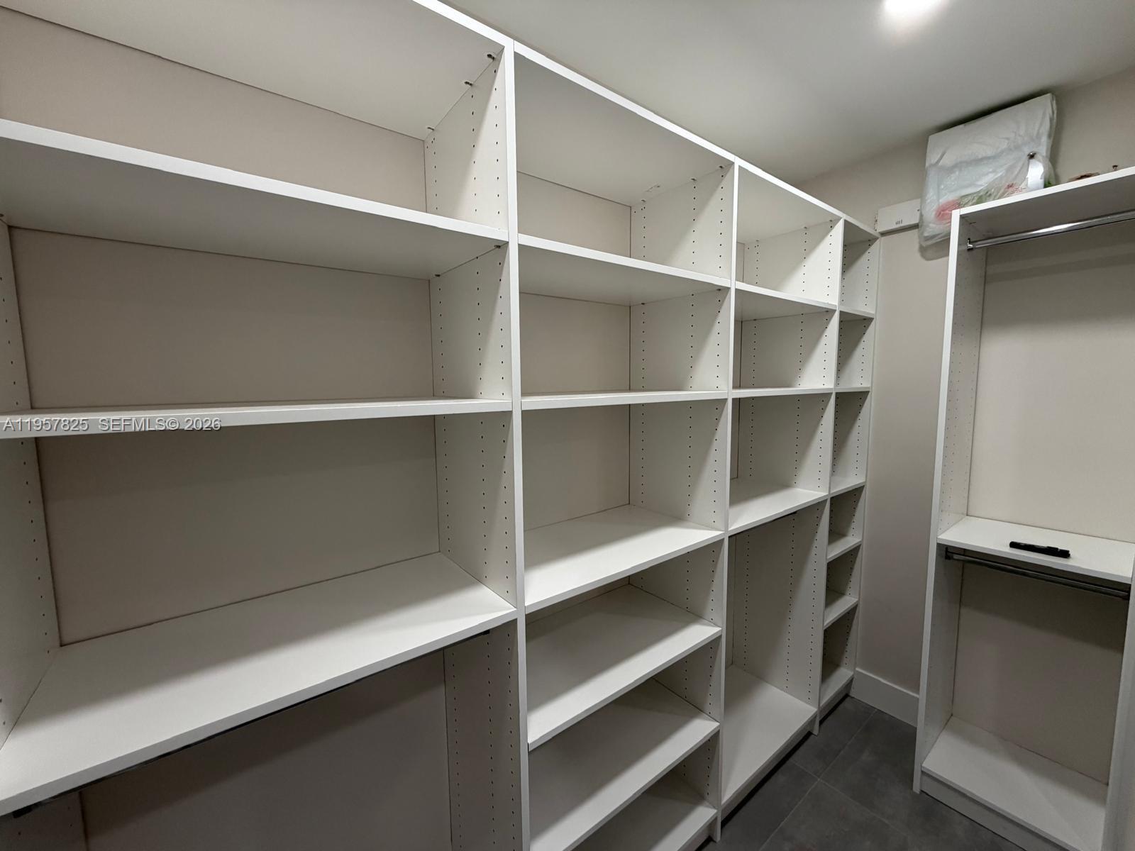 755 Falling Water Road Weston, FL 33326 - Photo 29 of 52 a view of walk in closet with empty racks