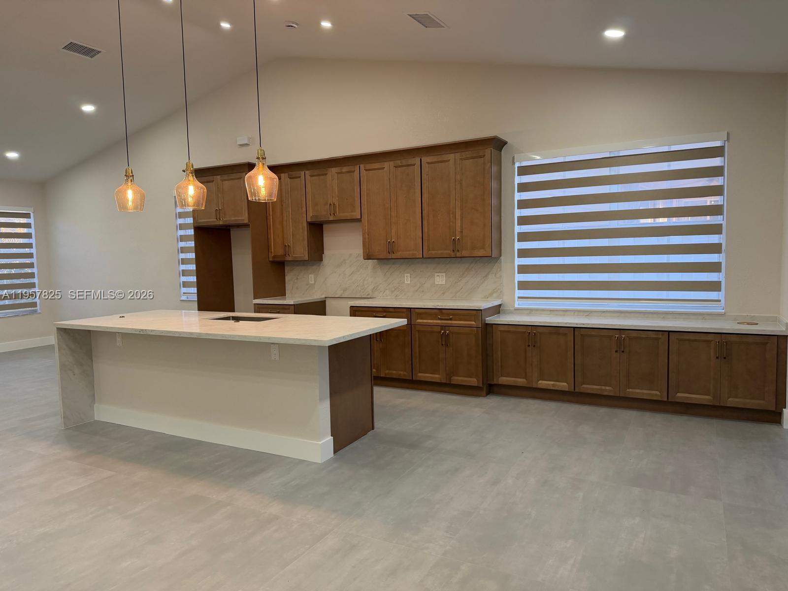 755 Falling Water Road Weston, FL 33326 - Photo 3 of 52 a kitchen with kitchen island a sink stainless steel appliances and cabinets