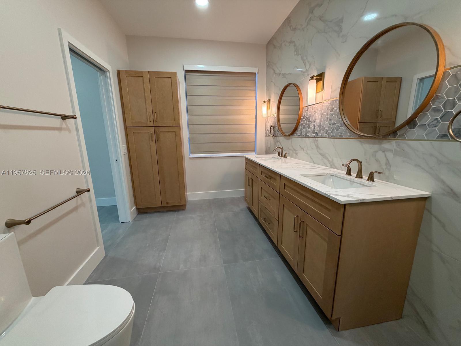 755 Falling Water Road Weston, FL 33326 - Photo 31 of 52 a bathroom with a sink and a mirror