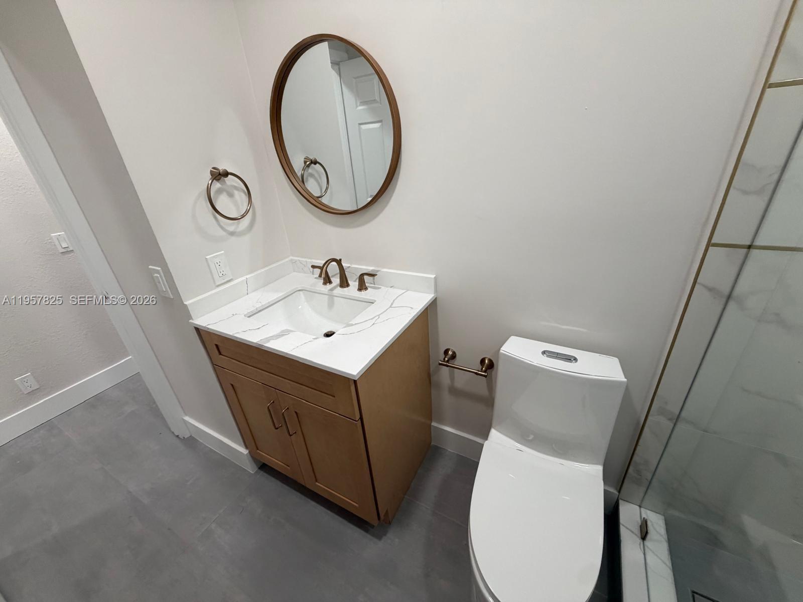 755 Falling Water Road Weston, FL 33326 - Photo 34 of 52 a bathroom with a toilet sink vanity and mirror