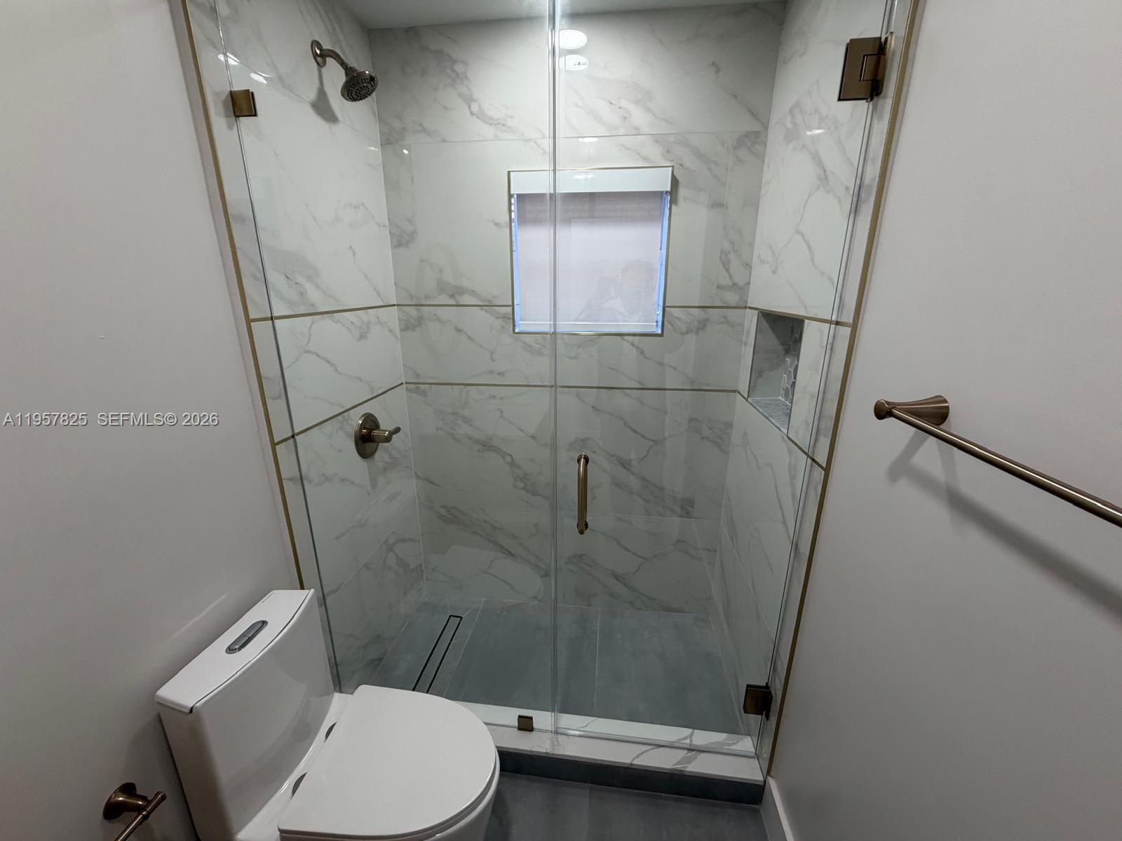 755 Falling Water Road Weston, FL 33326 - Photo 35 of 52 a bathroom with a toilet and a shower