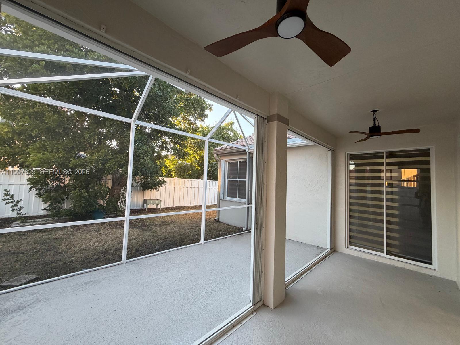 755 Falling Water Road Weston, FL 33326 - Photo 41 of 52 a view of an empty room with a fireplace and windows
