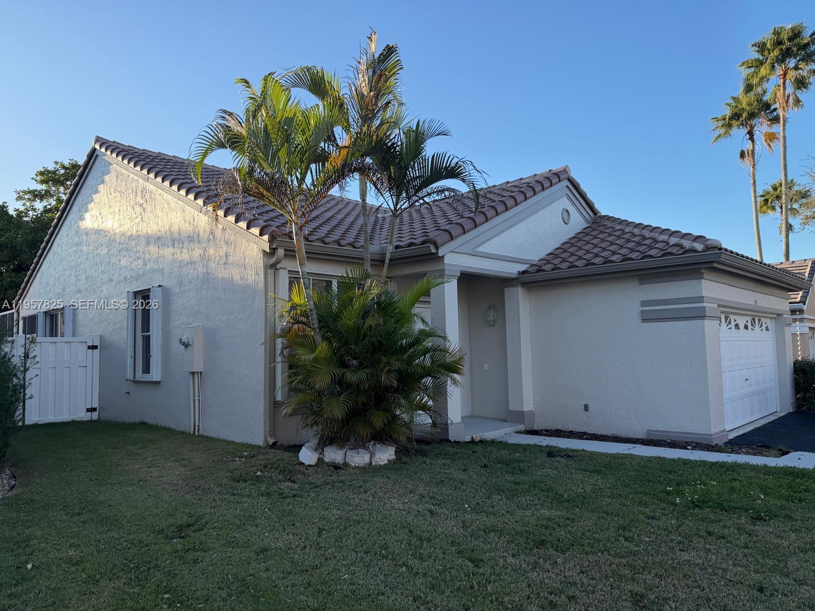 755 Falling Water Road Weston, FL 33326 - Photo 46 of 52 a front view of a house with a garden