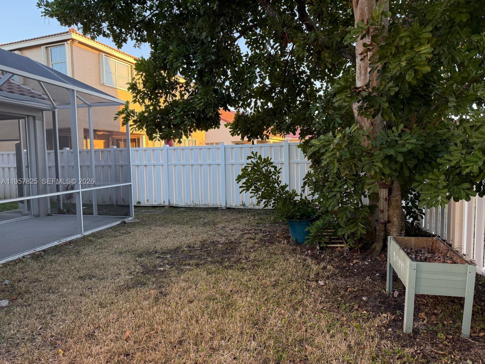 755 Falling Water Road Weston, FL 33326 - Photo 51 of 52 a backyard of a house with lots of green space