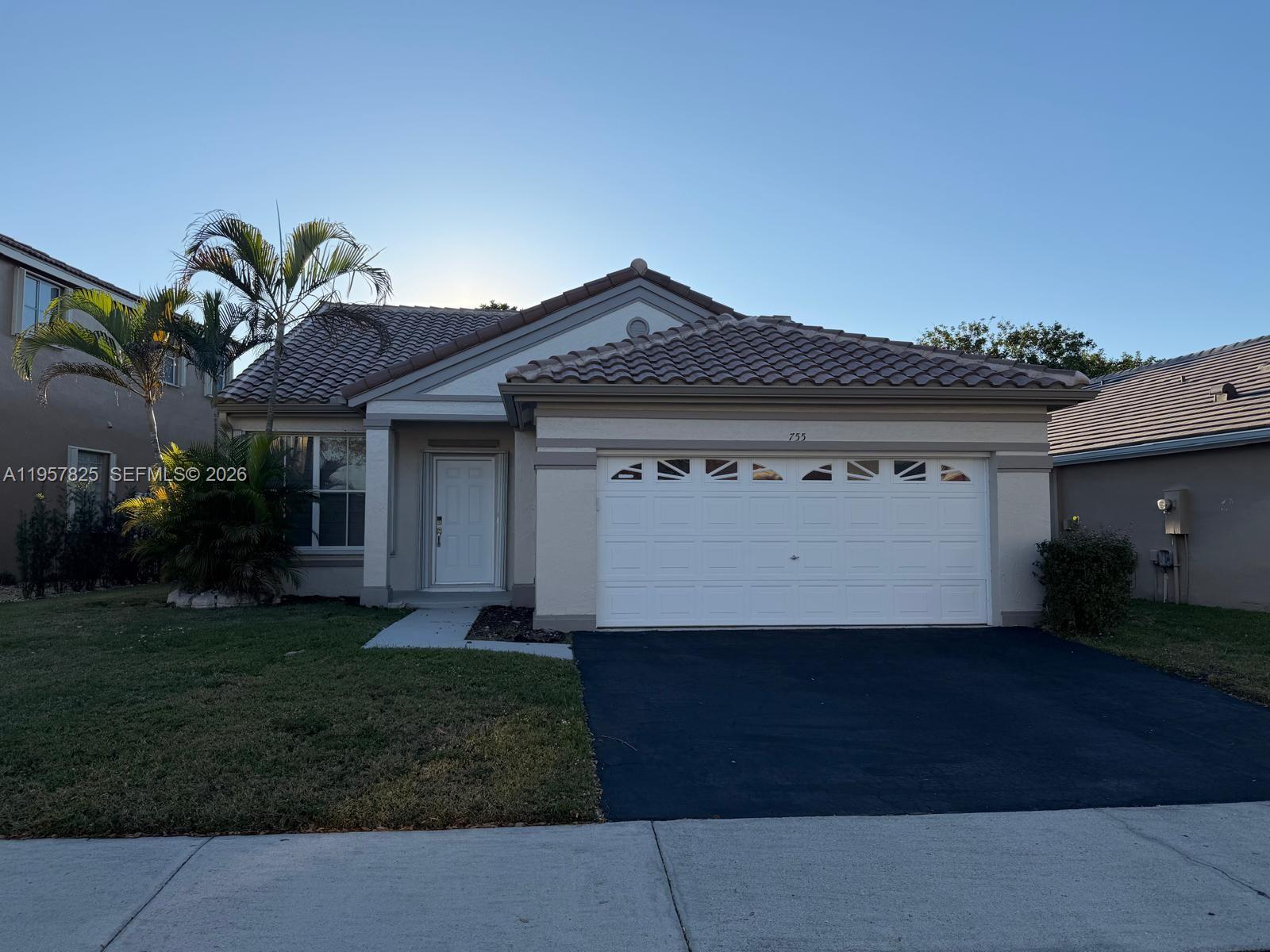 755 Falling Water Road Weston, FL 33326 - Photo 52 of 52 a front view of a house with a yard and garage