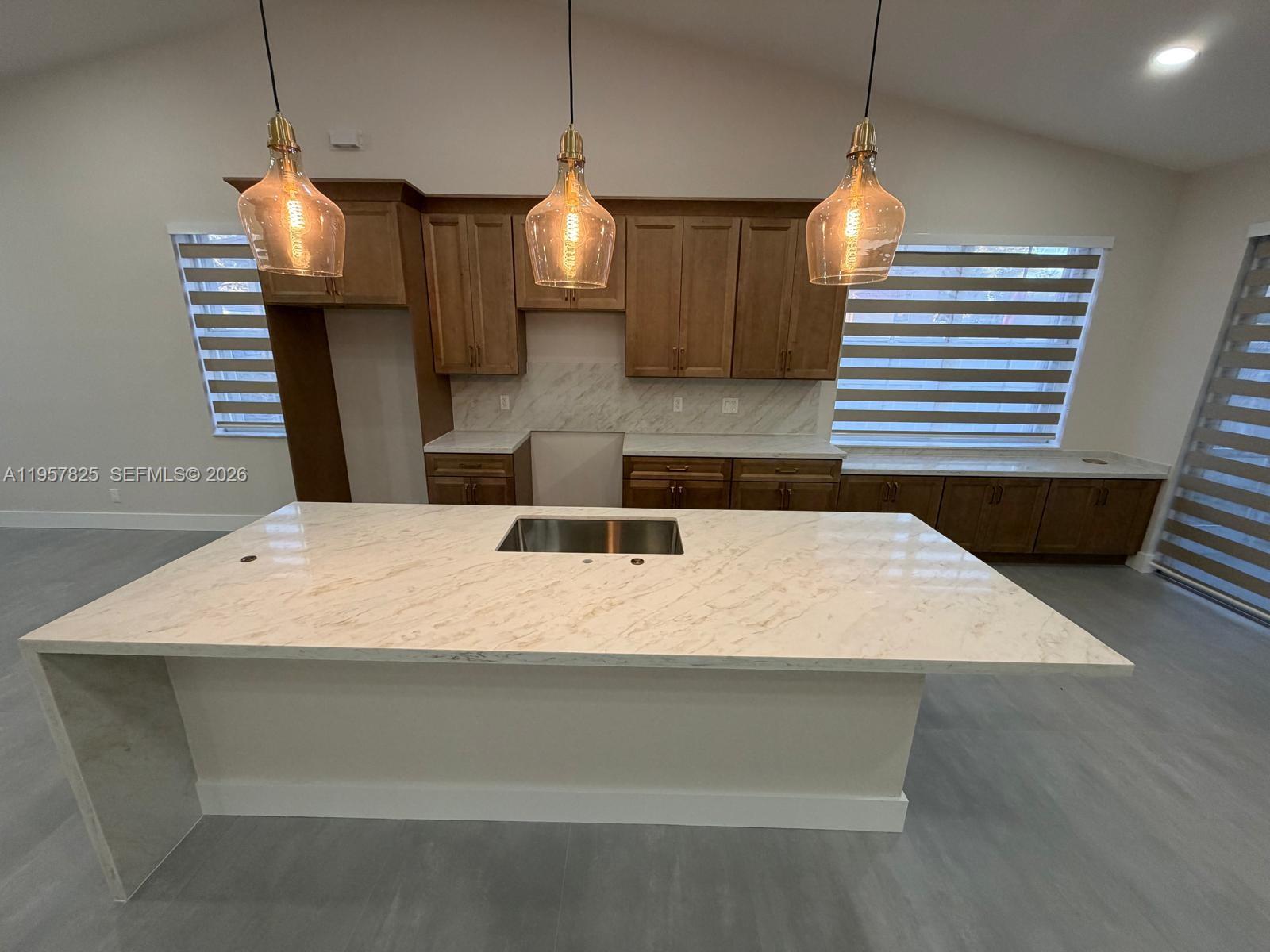 755 Falling Water Road Weston, FL 33326 - Photo 7 of 52 a large kitchen with kitchen island a counter space a sink and appliances