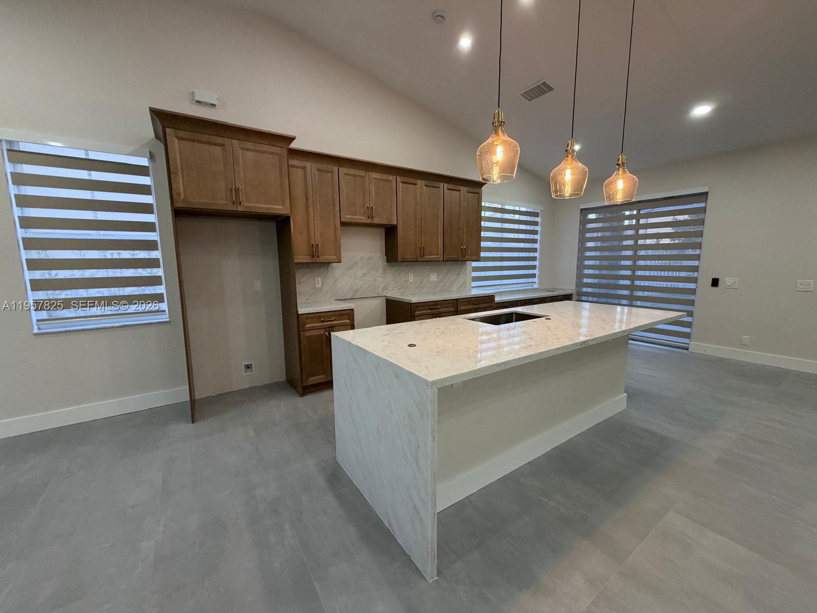 755 Falling Water Road Weston, FL 33326 - Photo 9 of 52 a kitchen that has a lot of cabinets in it