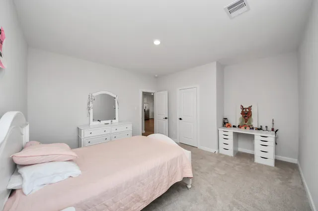 a bedroom with a bed and a cabinets