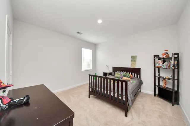a view of a bedroom with furniture and toys