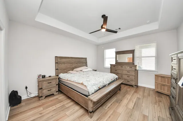 a bedroom with a bed and a view of kitchen