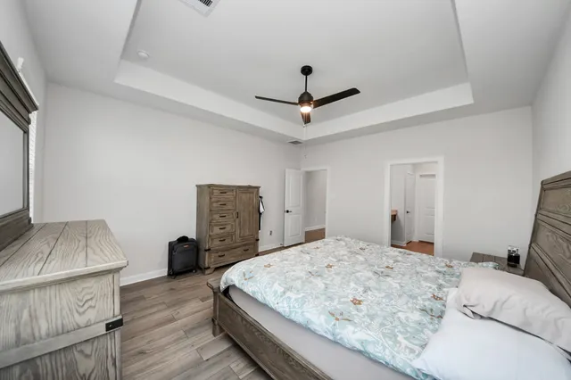 a bedroom with a bed and a dresser in it