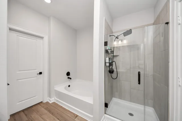 a bathroom with a bathtub and a shower