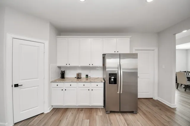 a kitchen with a refrigerator sink and cabinets