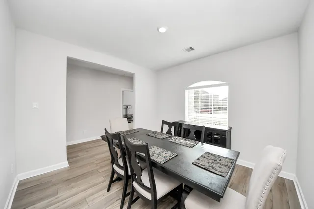 a view of a dining room with furniture and wooden floor