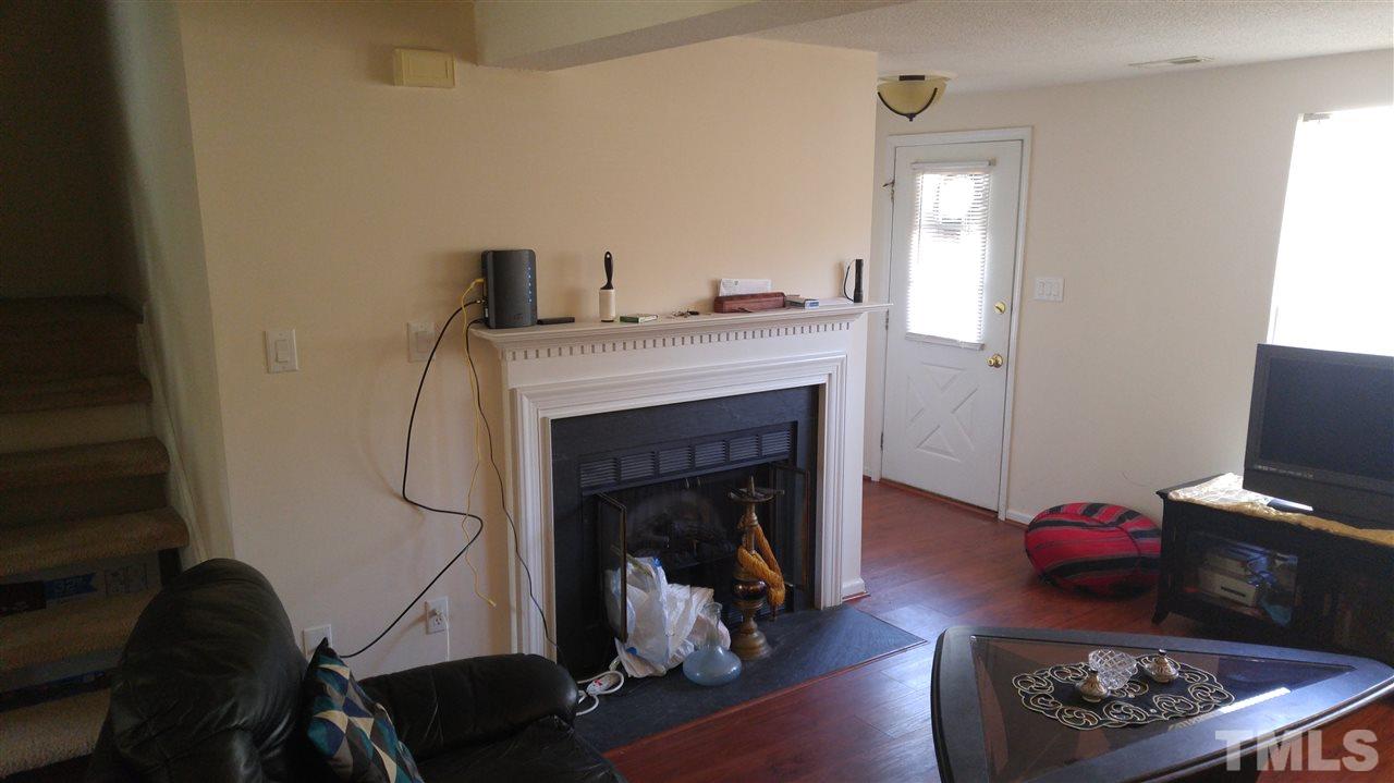 4311 Halliwell Drive Raleigh, NC 27606 - Photo 11 of 21 a living room with furniture and a fireplace
