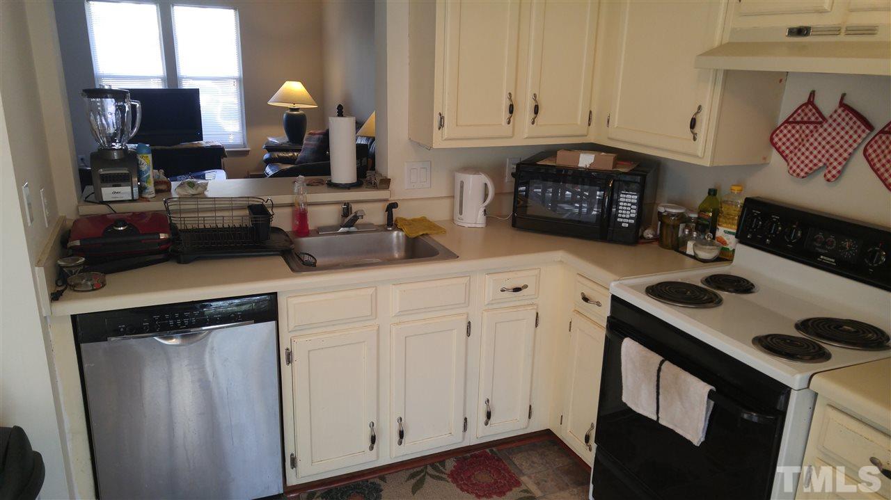 4311 Halliwell Drive Raleigh, NC 27606 - Photo 13 of 21 a kitchen with white cabinets and sink