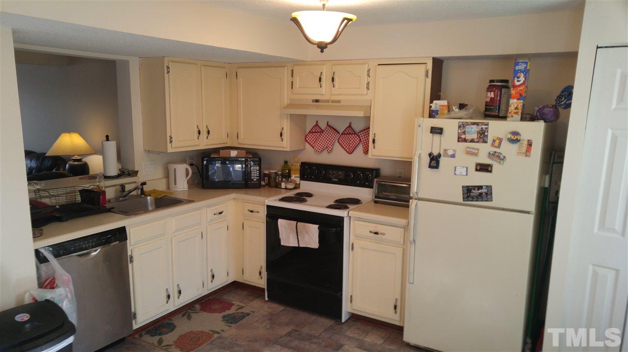 4311 Halliwell Drive Raleigh, NC 27606 - Photo 14 of 21 a kitchen with a refrigerator and a stove
