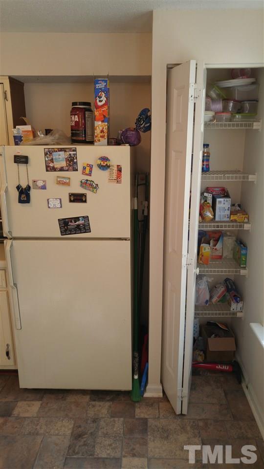 4311 Halliwell Drive Raleigh, NC 27606 - Photo 17 of 21 a white refrigerator freezer sitting inside of a kitchen