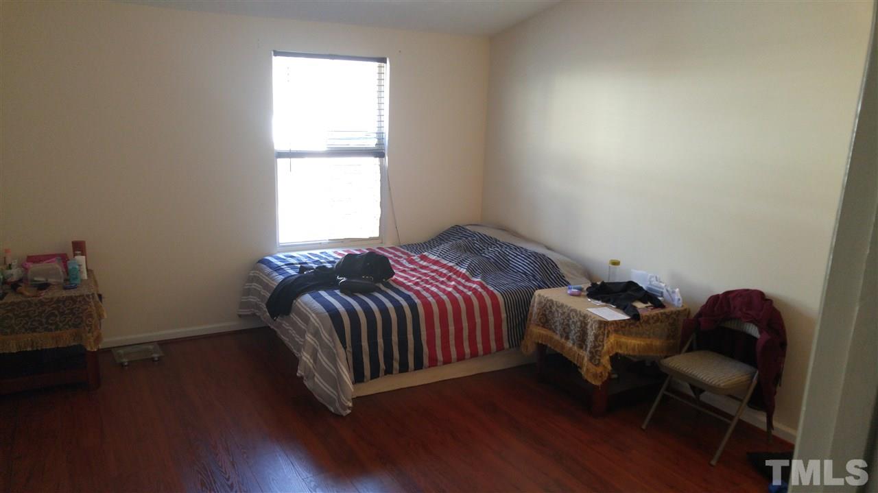 4311 Halliwell Drive Raleigh, NC 27606 - Photo 18 of 21 a bed sitting in a bedroom next to a window