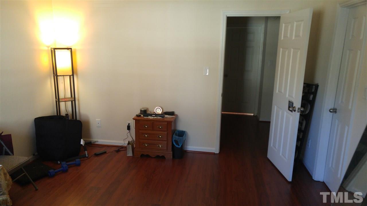 4311 Halliwell Drive Raleigh, NC 27606 - Photo 19 of 21 a room with a desk and chair with wooden floor