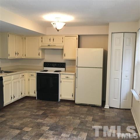 4311 Halliwell Drive Raleigh, NC 27606 - Photo 3 of 21 a white refrigerator freezer sitting in a kitchen