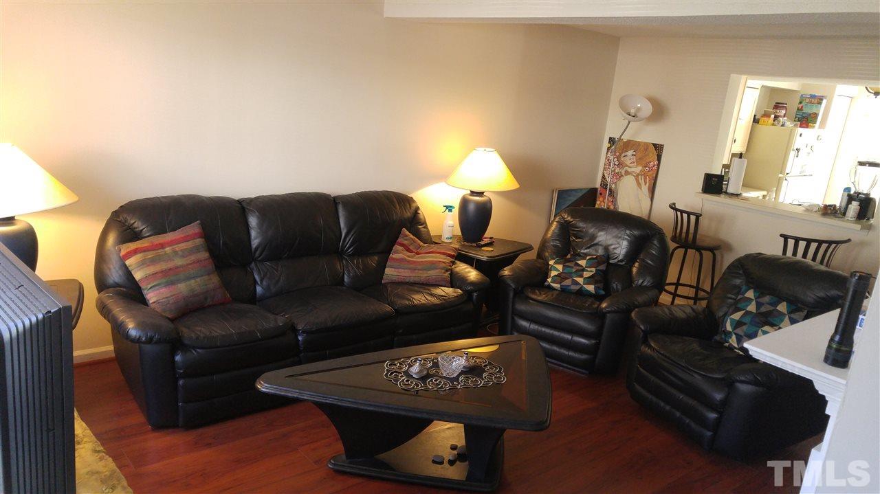 4311 Halliwell Drive Raleigh, NC 27606 - Photo 9 of 21 a living room with furniture and a lamp