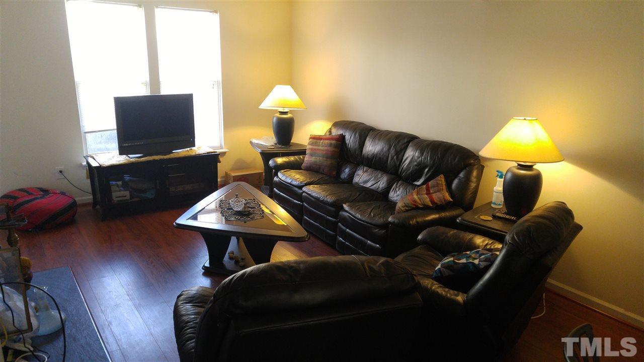 4311 Halliwell Drive Raleigh, NC 27606 - Photo 10 of 21 a living room with furniture and a flat screen tv