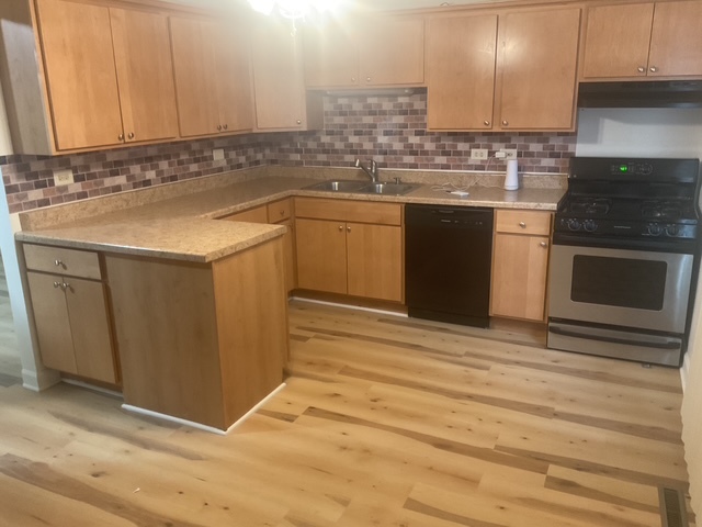 2223 171st Street Hazel Crest, IL 60429 - Photo 3 of 12 a kitchen with a sink cabinets and stainless steel appliances