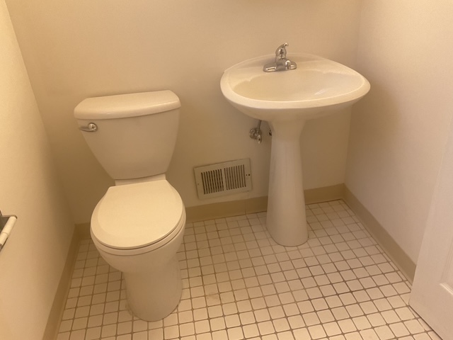 2223 171st Street Hazel Crest, IL 60429 - Photo 9 of 12 a bathroom with a toilet sink and mirror