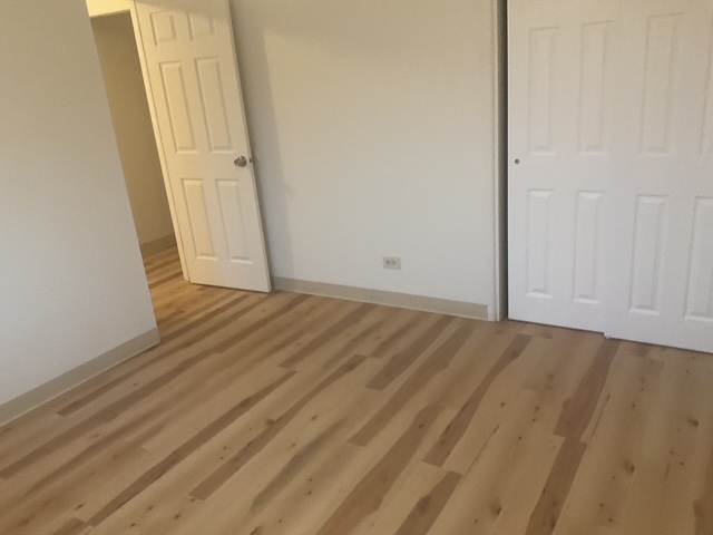 2223 171st Street Hazel Crest, IL 60429 - Photo 10 of 12 an empty room with wooden floor
