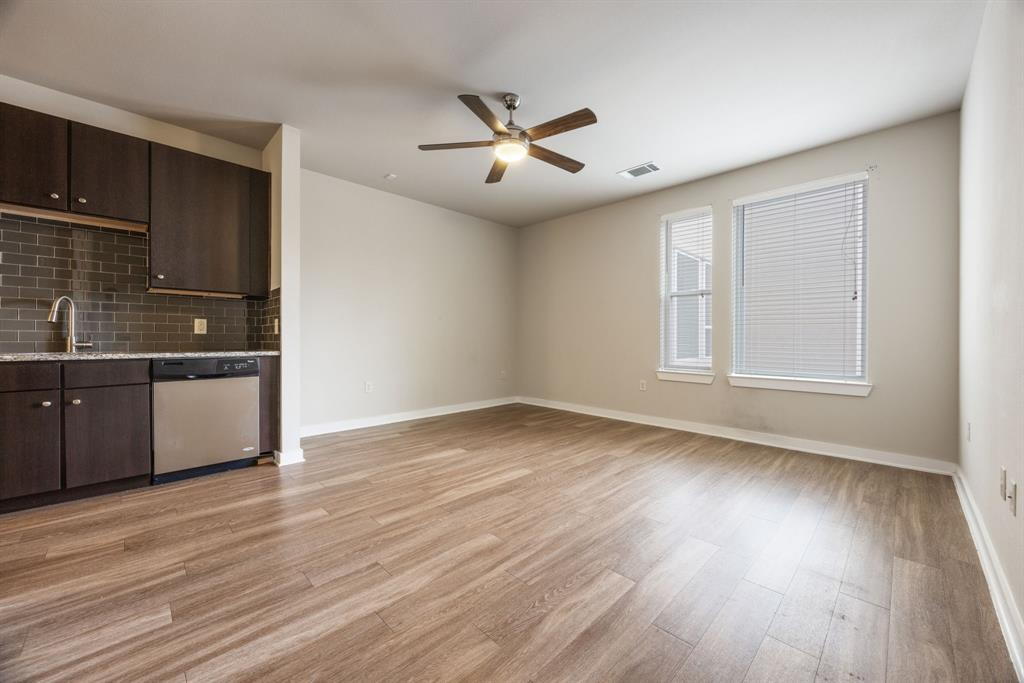 1900 Barton Springs Road, Unit 3013 Austin, TX 78704 - Photo 11 of 27 A combined living area and kitchen featuring sleek wood flooring and a modern ceiling fan.