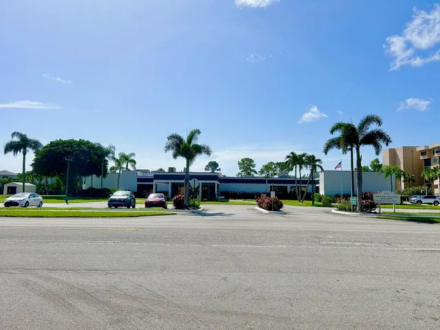 a view of street with cars parked in front of it
