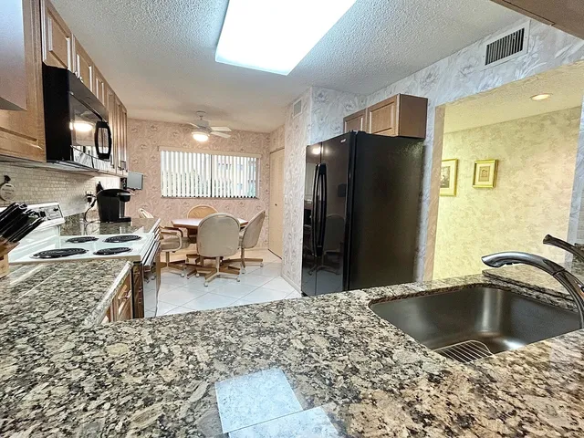 a kitchen with a refrigerator sink and stove