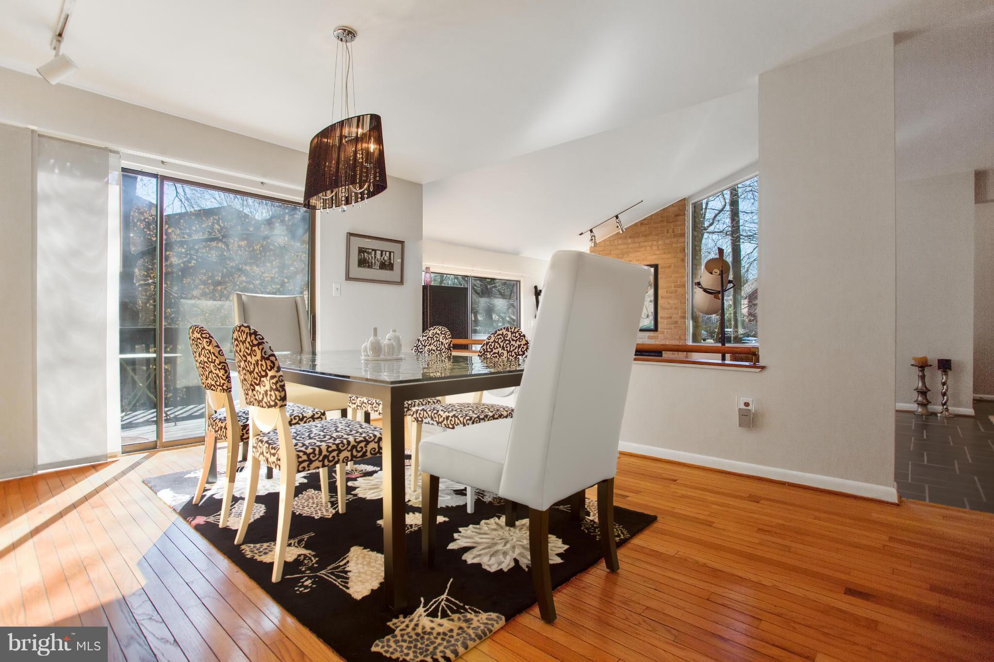 2040 Lakebreeze Way Reston, VA 20191 - Photo 13 of 29 a dining room with furniture a chandelier and wooden floor