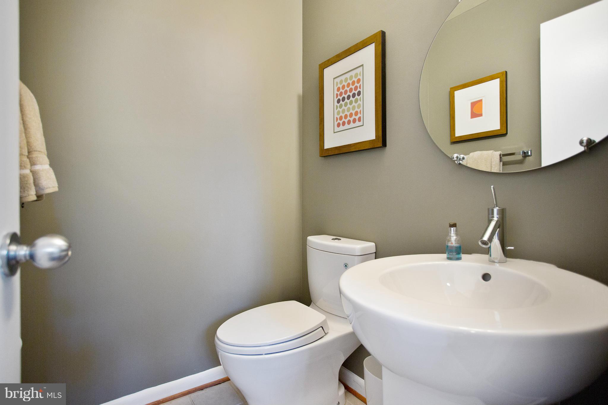 2040 Lakebreeze Way Reston, VA 20191 - Photo 14 of 29 a white toilet sitting next to a bathroom sink