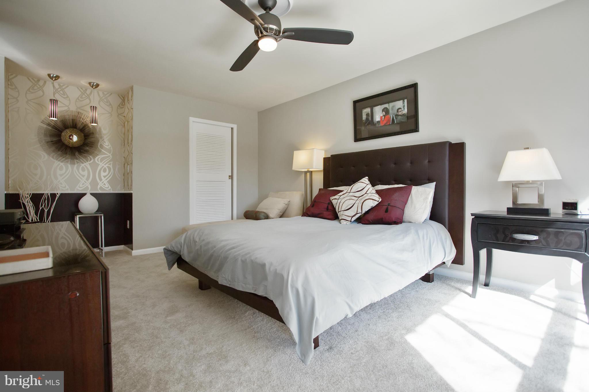 2040 Lakebreeze Way Reston, VA 20191 - Photo 16 of 29 a bedroom with a bed and wooden floor