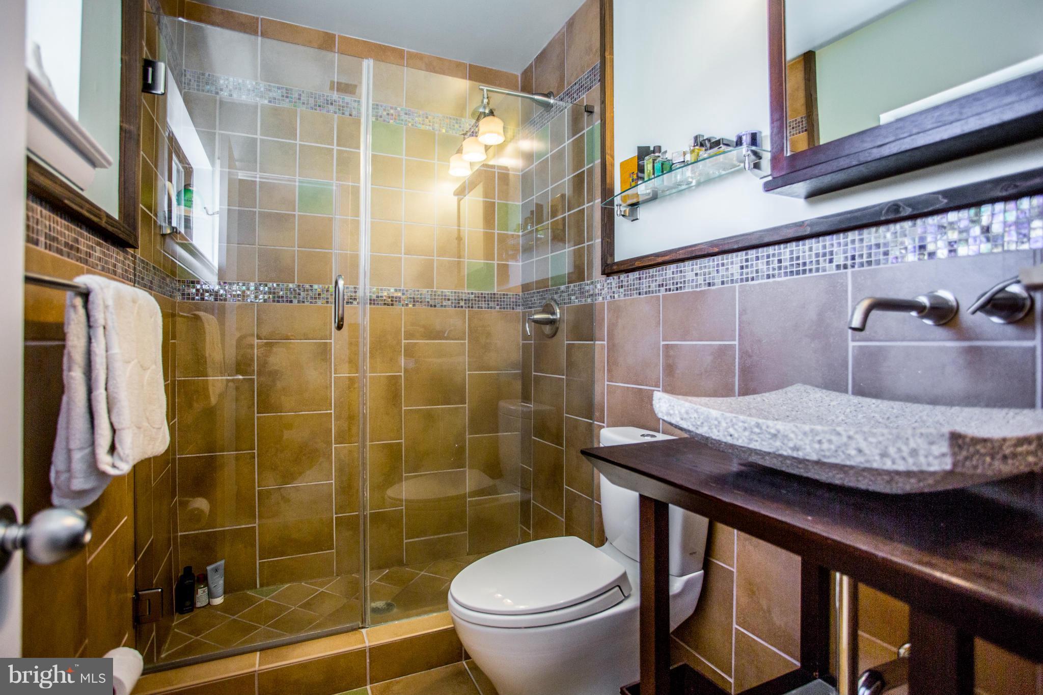 2040 Lakebreeze Way Reston, VA 20191 - Photo 18 of 29 a bathroom with a granite countertop sink toilet and shower