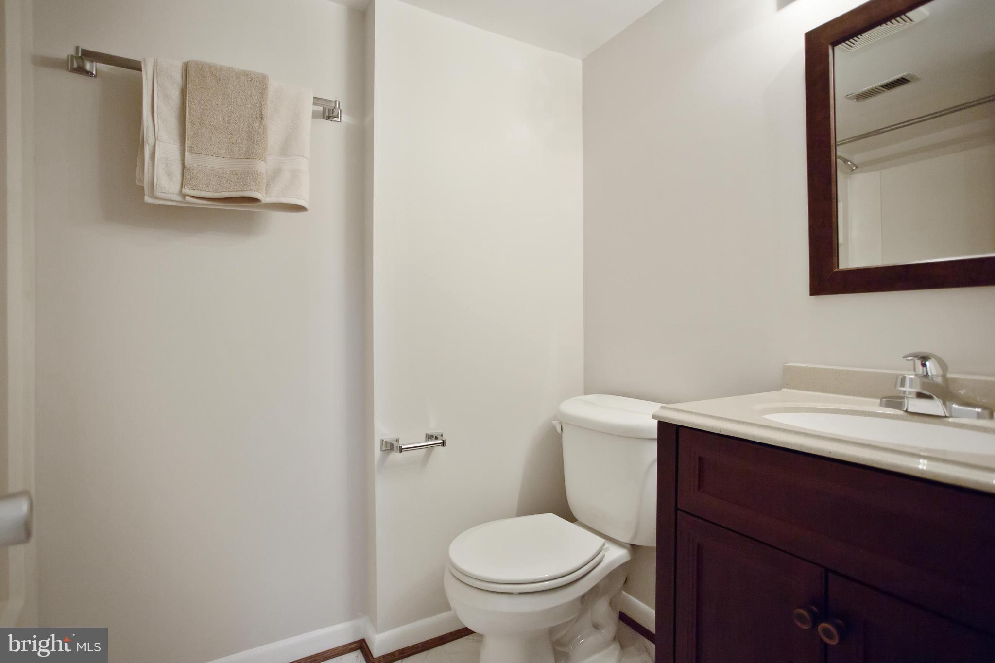 2040 Lakebreeze Way Reston, VA 20191 - Photo 24 of 29 a bathroom with a granite countertop sink toilet and mirror