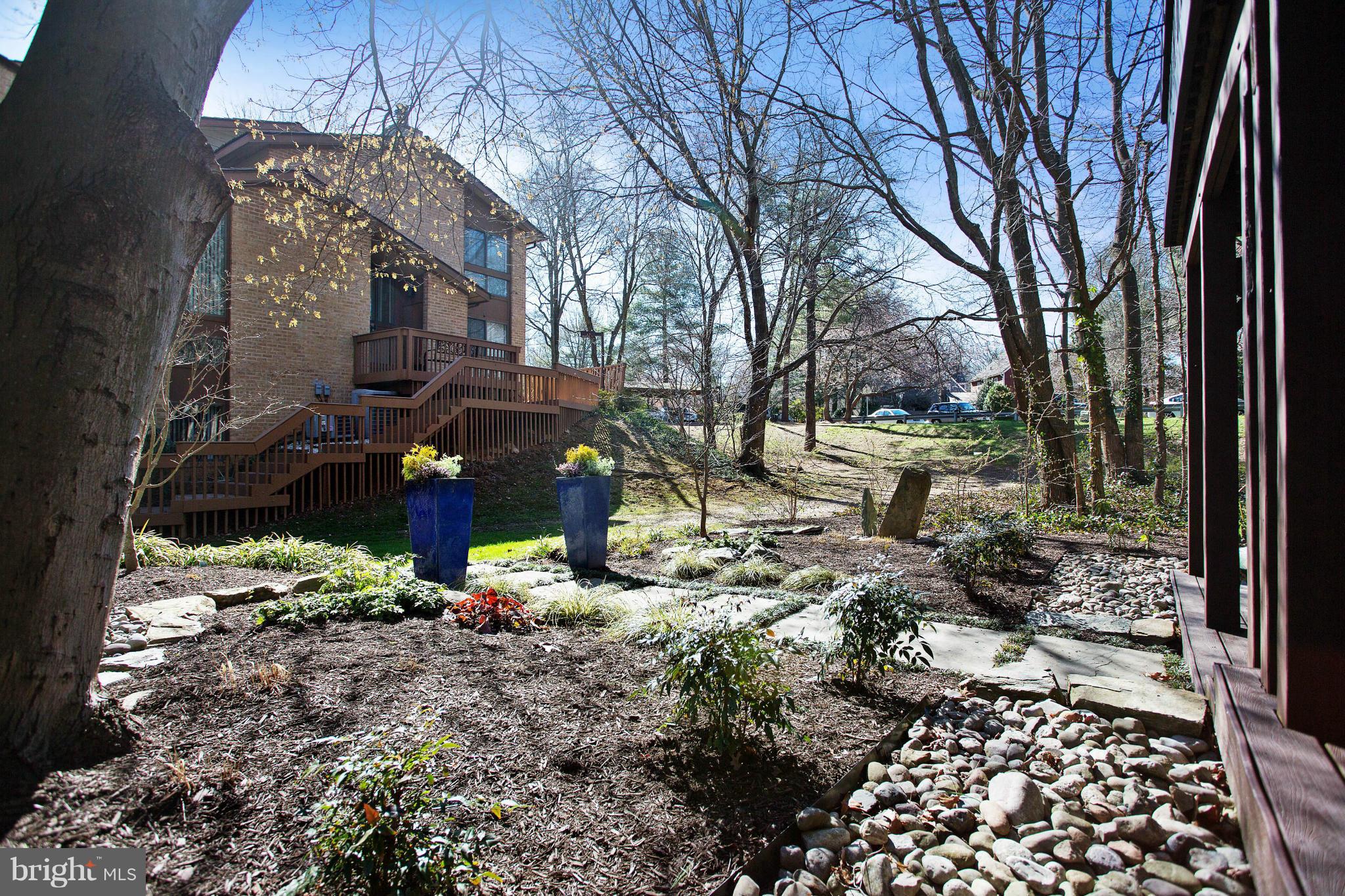 2040 Lakebreeze Way Reston, VA 20191 - Photo 28 of 29 a view of a yard with plants and a large tree