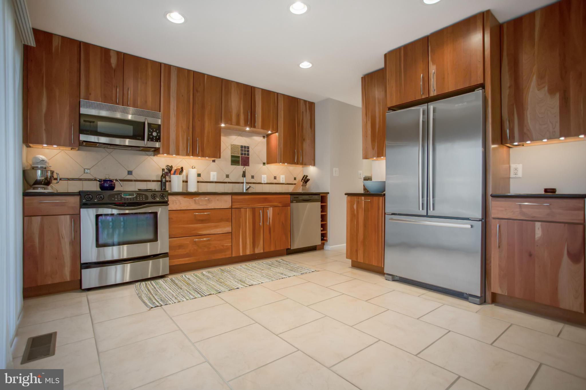 2040 Lakebreeze Way Reston, VA 20191 - Photo 7 of 29 a kitchen with stainless steel appliances granite countertop a stove a sink dishwasher a refrigerator and a microwave oven with large cabinets